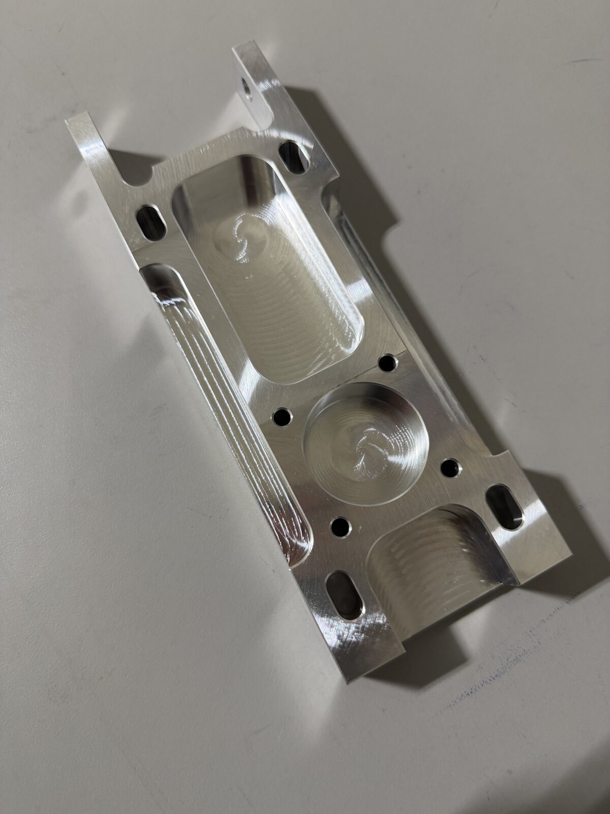 Machined aluminum housing with deep pockets and rounded internal features