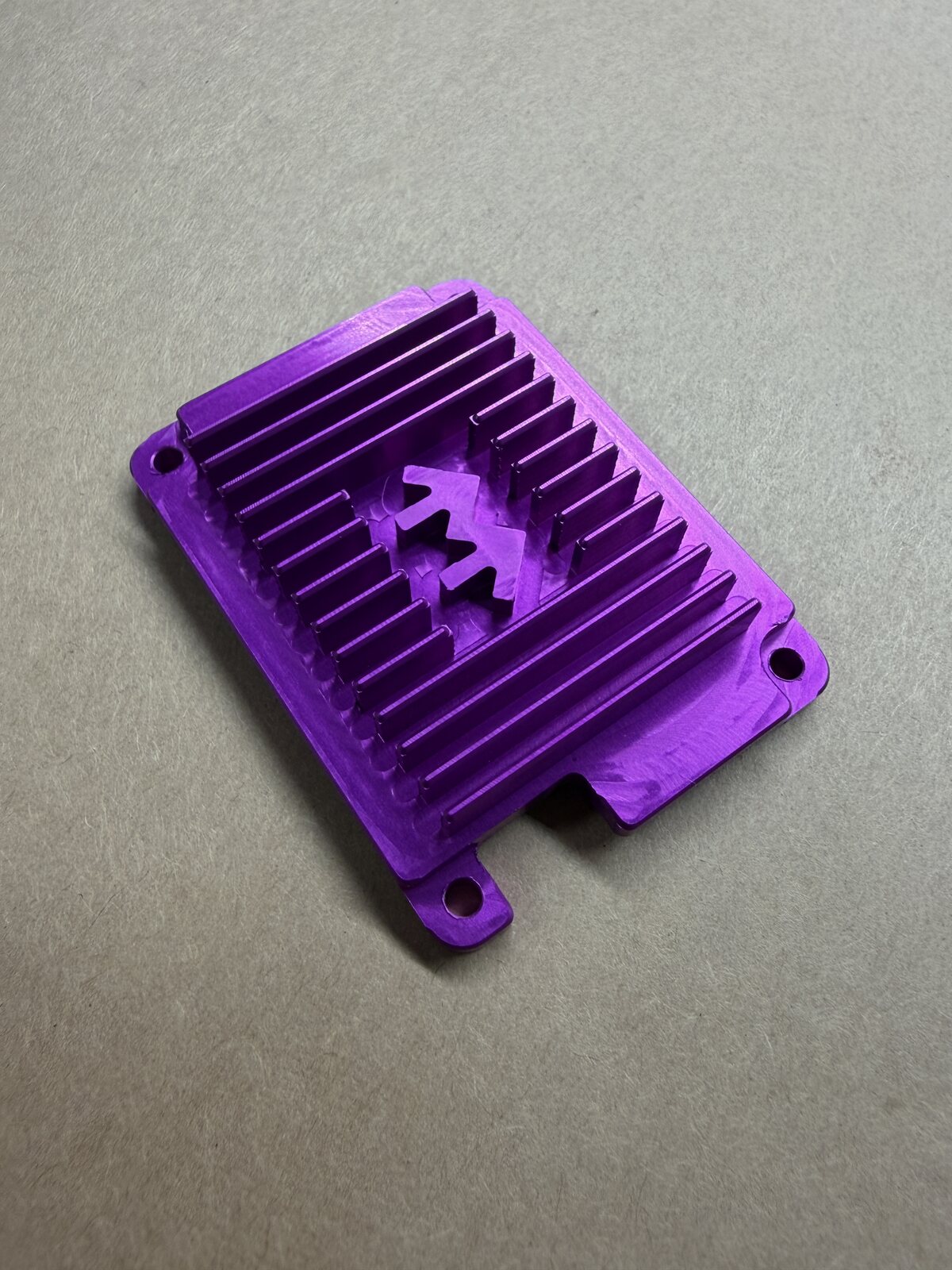 Machined aluminum component photographed from above