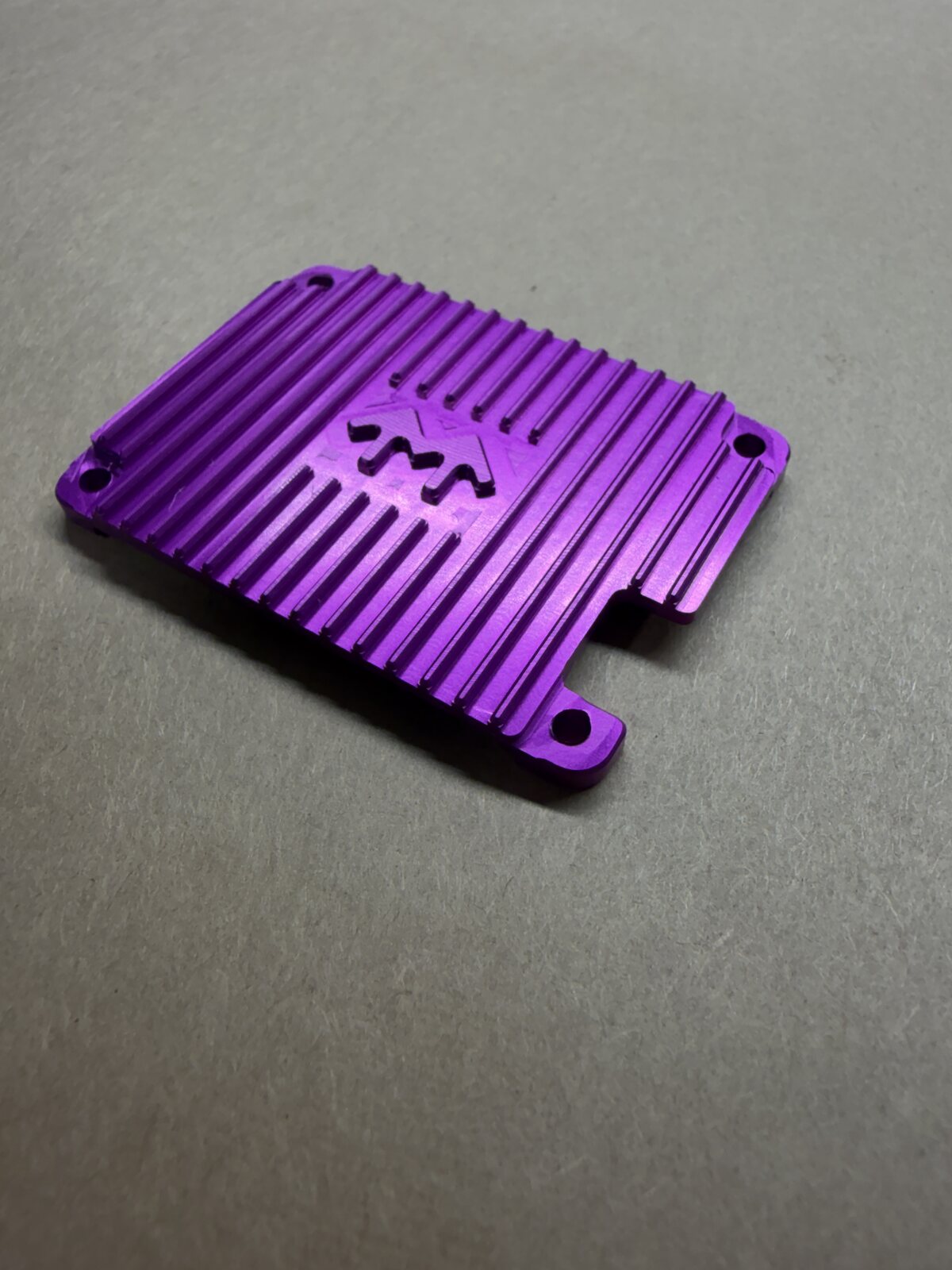 Purple anodized aluminum part with detailed cooling fins
